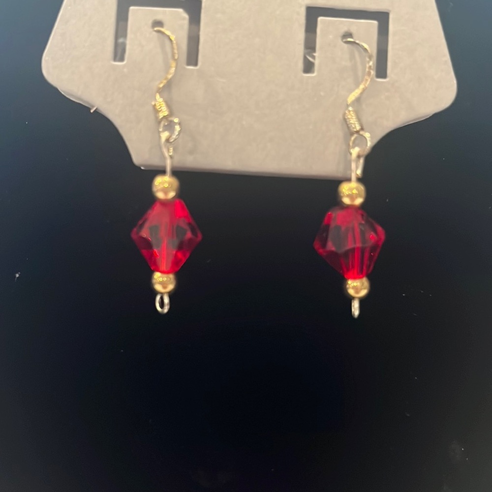 Red and gold earrings handed